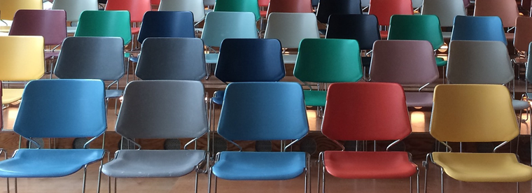 Rows of colorful auditorium chairs in conference hall seating arrangement