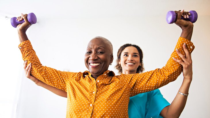 Physical therapist taking care of senior paitent