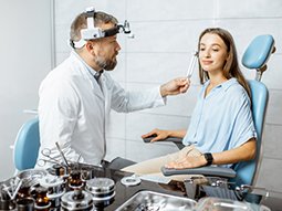 Patient having hearing test with tuning fork by audiologist
