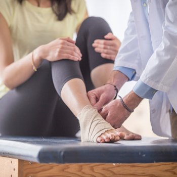 Health professional and patient with foot injury
