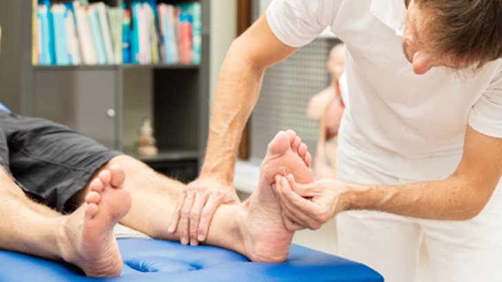 Doctor examining paitent’s foot