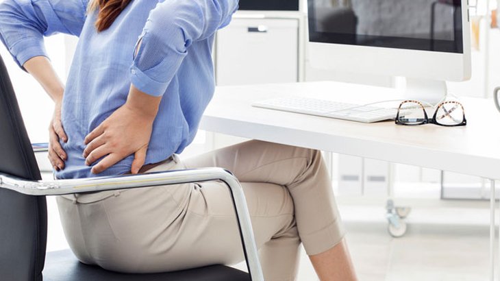 Young woman suffering from back pain