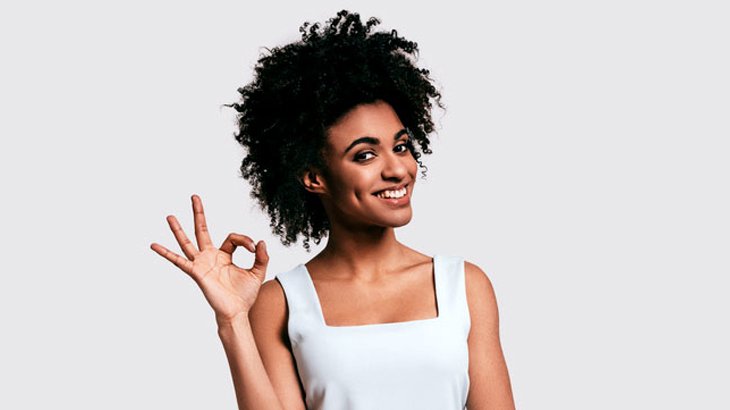 woman makes an okay sign with her right hand
