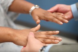 Health professional examining patient’s hands