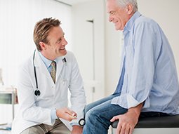 testicular specialists talking with senior patient