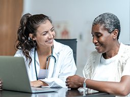 Young Female Doctor with Elderly Patient